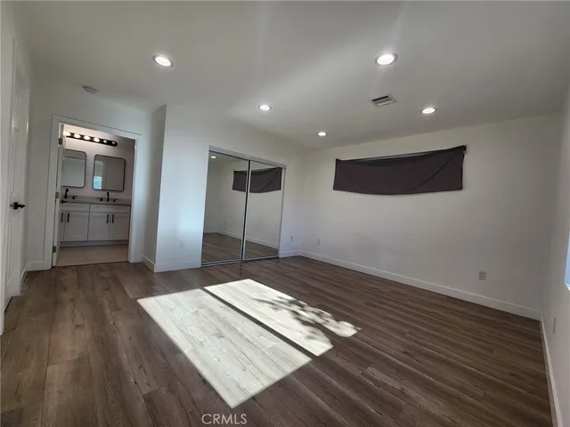a living room with hard wood floors and furniture
