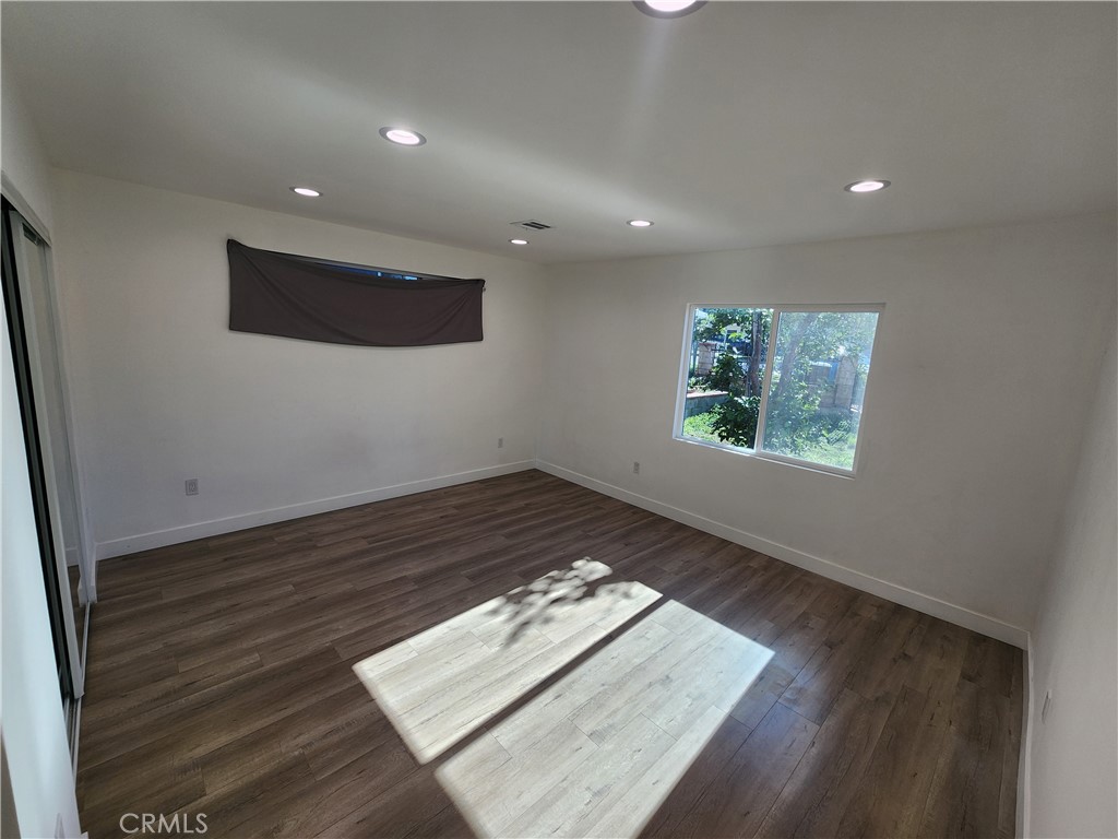 7665 Machrea Street Tujunga, CA 91042 - Photo 17 of 43 an empty room with wooden floor and window