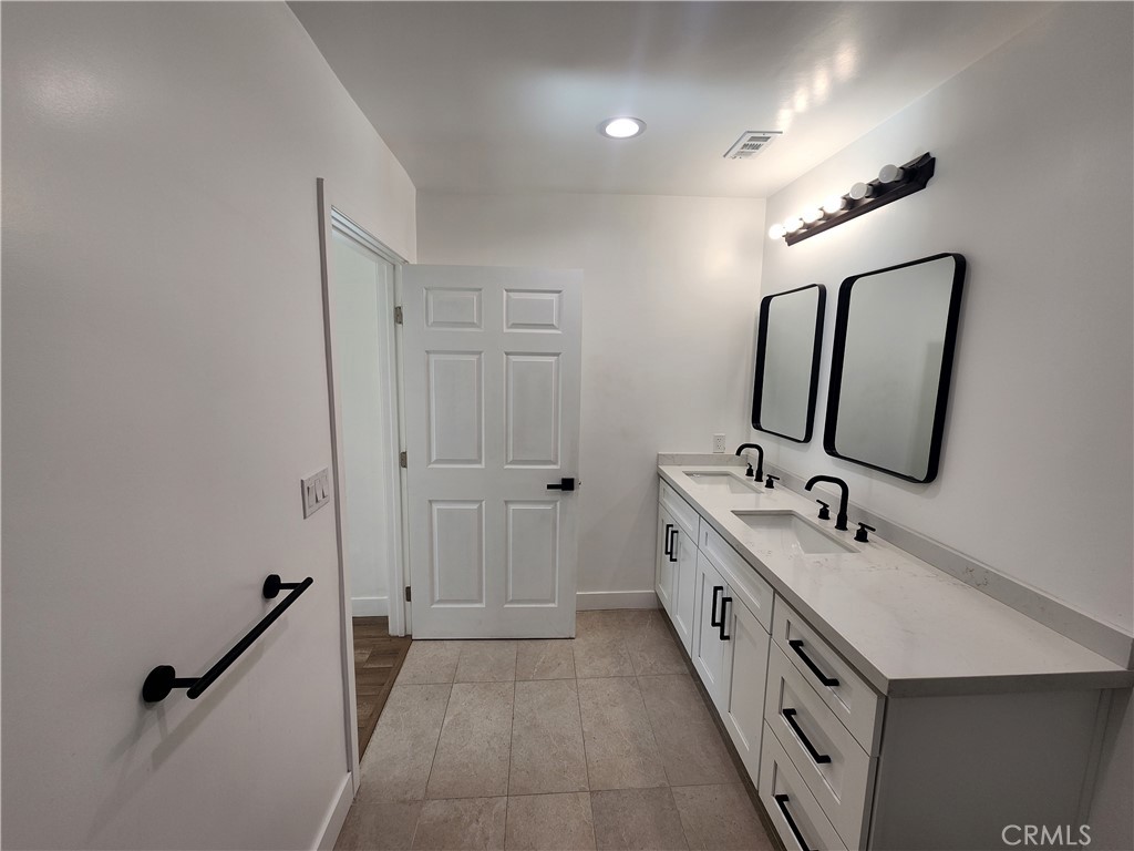 7665 Machrea Street Tujunga, CA 91042 - Photo 19 of 43 a bathroom with 2 sink tub and mirror