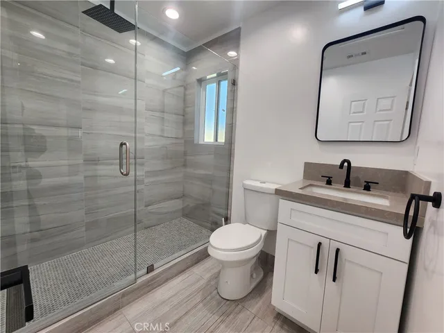 a bathroom with a toilet sink and shower