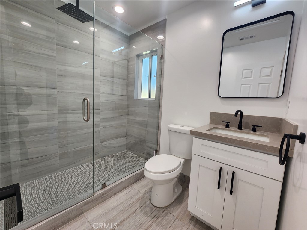 7665 Machrea Street Tujunga, CA 91042 - Photo 2 of 43 a bathroom with a toilet sink and shower