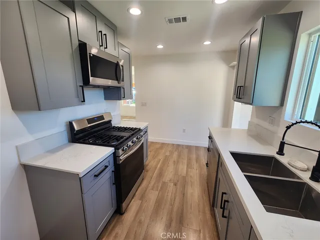 a kitchen with a sink stove and microwave