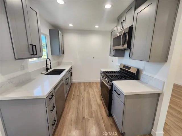a kitchen that has a sink and a stove in it