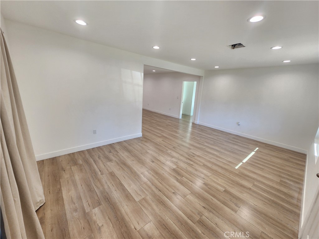 7665 Machrea Street Tujunga, CA 91042 - Photo 32 of 43 an empty room with wooden floor and natural light
