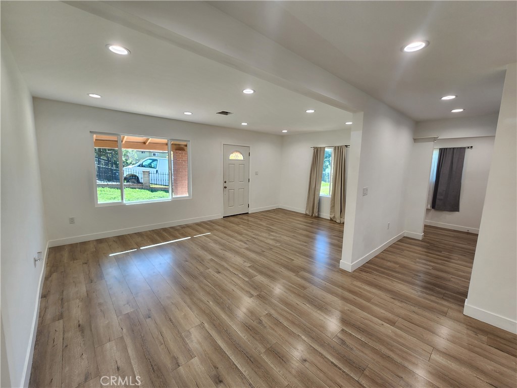7665 Machrea Street Tujunga, CA 91042 - Photo 36 of 43 an empty room with wooden floor and windows