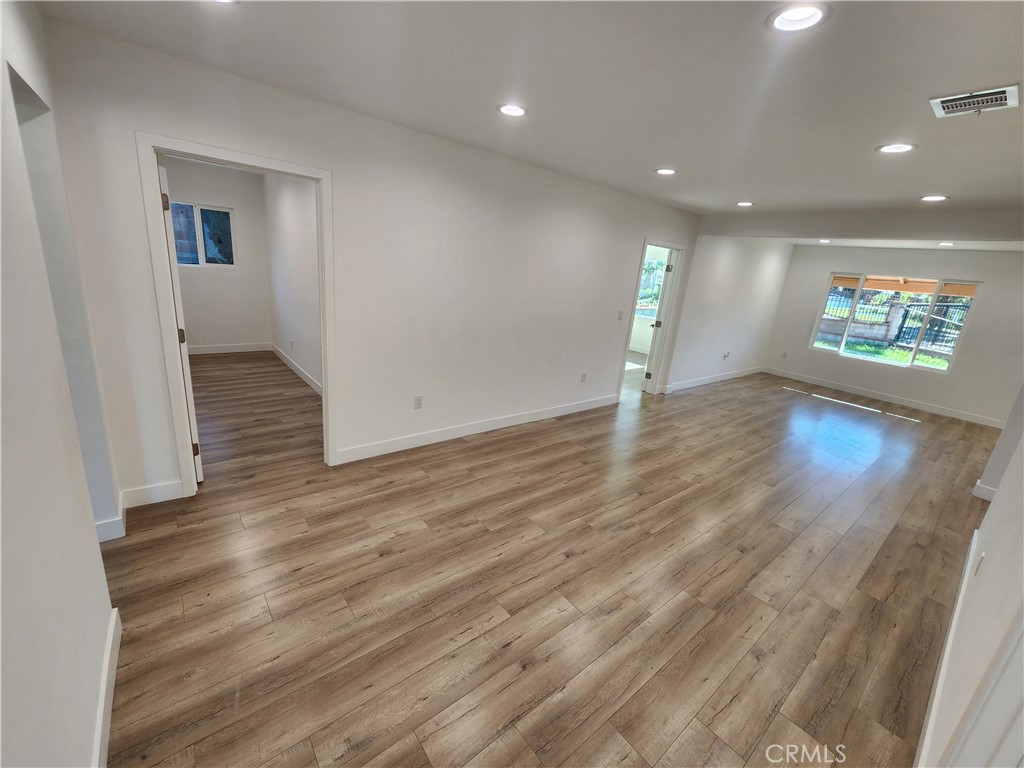 7665 Machrea Street Tujunga, CA 91042 - Photo 38 of 43 an empty room with wooden floor and windows