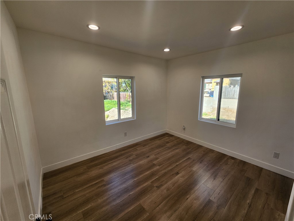 7665 Machrea Street Tujunga, CA 91042 - Photo 5 of 43 an empty room with wooden floor and windows