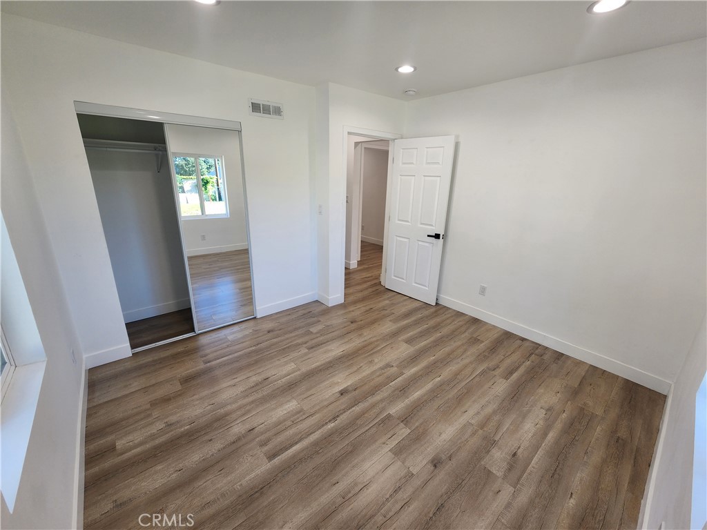 7665 Machrea Street Tujunga, CA 91042 - Photo 6 of 43 wooden floor in an empty room with a window