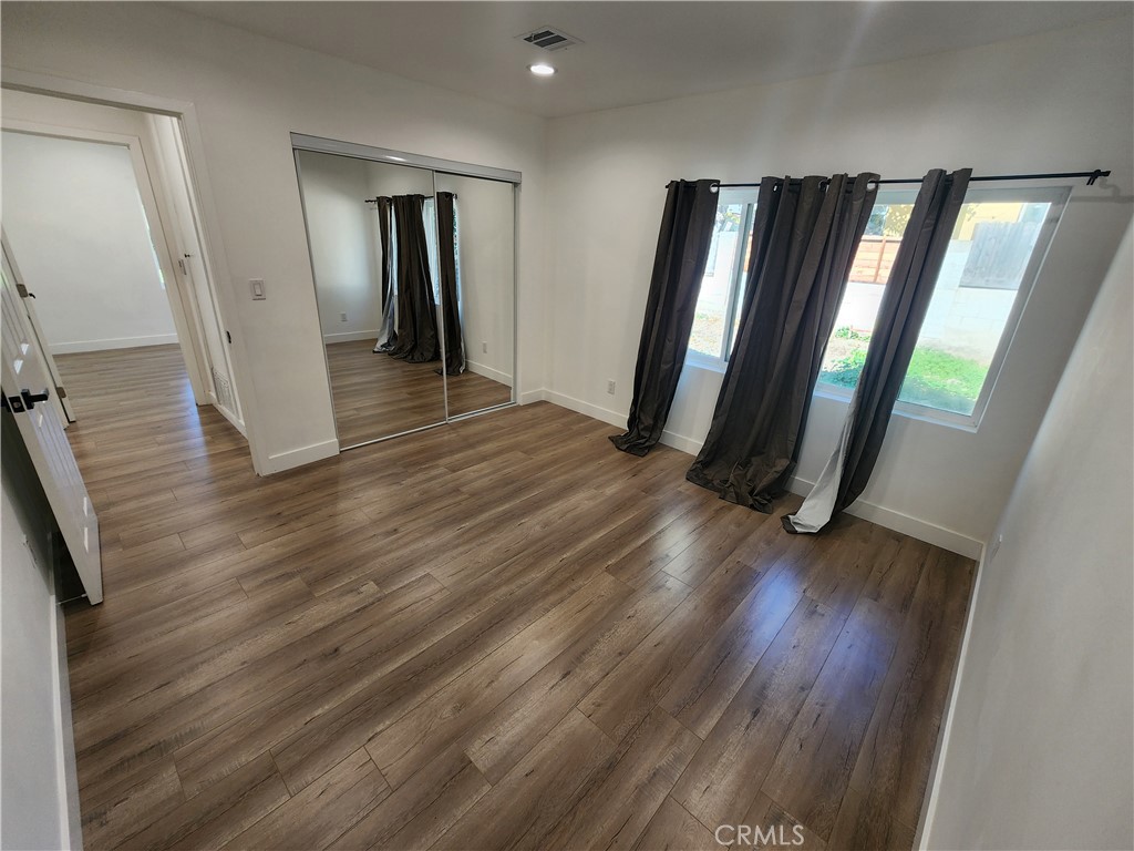 7665 Machrea Street Tujunga, CA 91042 - Photo 10 of 43 wooden floor in an empty room with a mirror