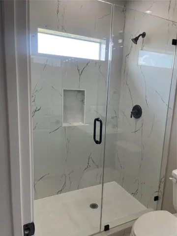 a bathroom with a shower and toilet