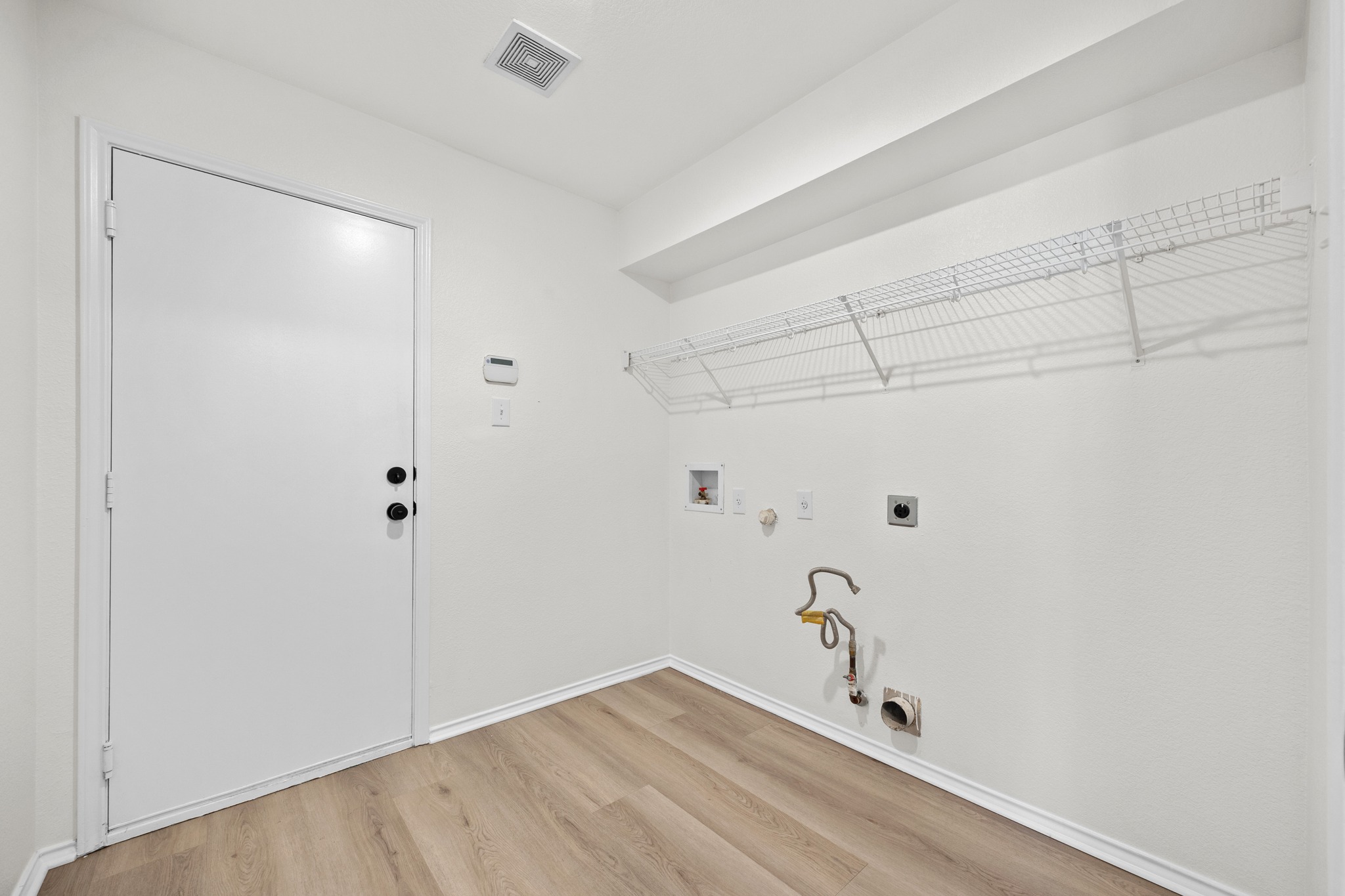 1818 Lost Maples Loop Cedar Park, TX 78613 - Photo 15 of 38 A well-organized laundry area offers practical space with wire shelving and durable flooring.