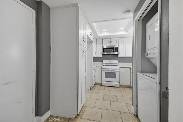 a kitchen with a stove a sink and a microwave