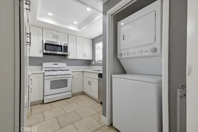 a kitchen with appliances a sink and cabinets