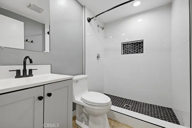 a bathroom with a shower and a toilet