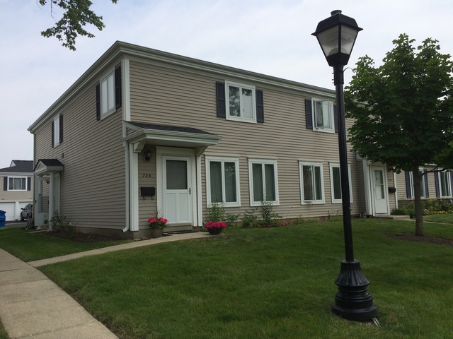 726 East Old Willow Road, Unit 104C Prospect Heights, IL 60070 - Photo 1 of 6 a front view of a house with garden