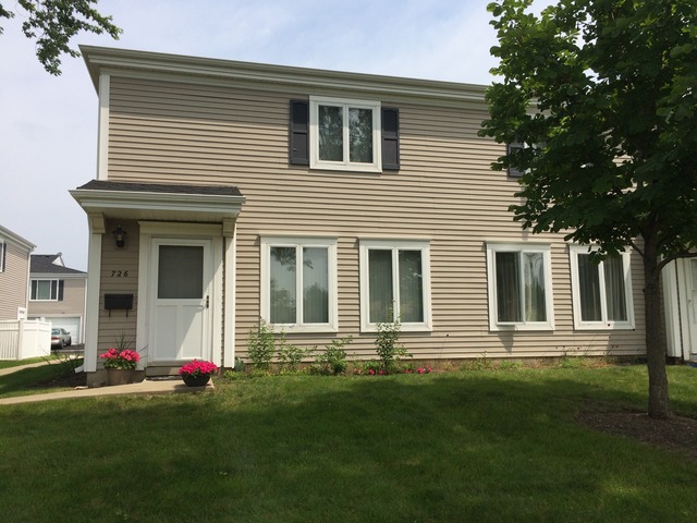 726 East Old Willow Road, Unit 104C Prospect Heights, IL 60070 - Photo 2 of 6 a front view of a house with a yard
