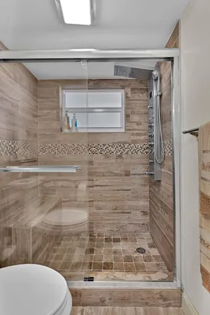 a bathroom with a toilet and a shower