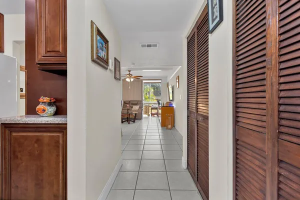a hallway with a dining table and chairs