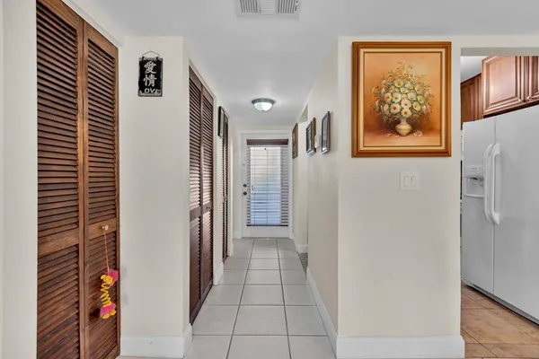 a view of a hallway to rooms and stairs