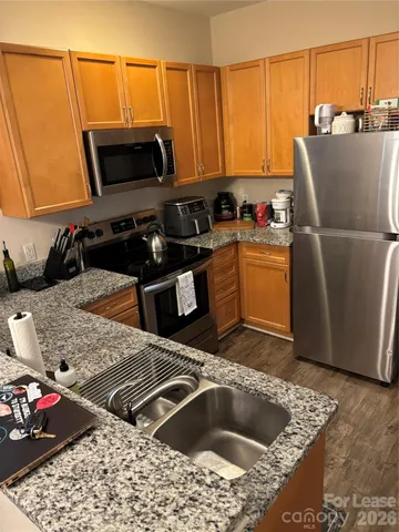 a kitchen with a sink a stove and a microwave