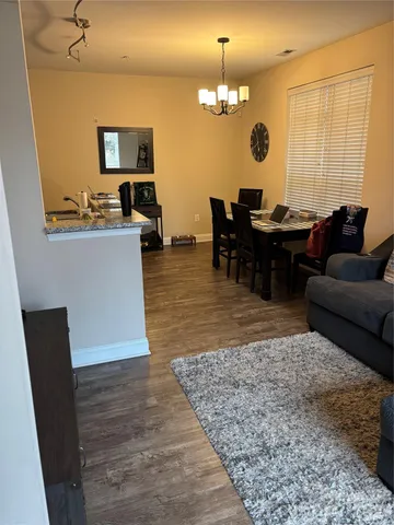 a living room with furniture and a chandelier