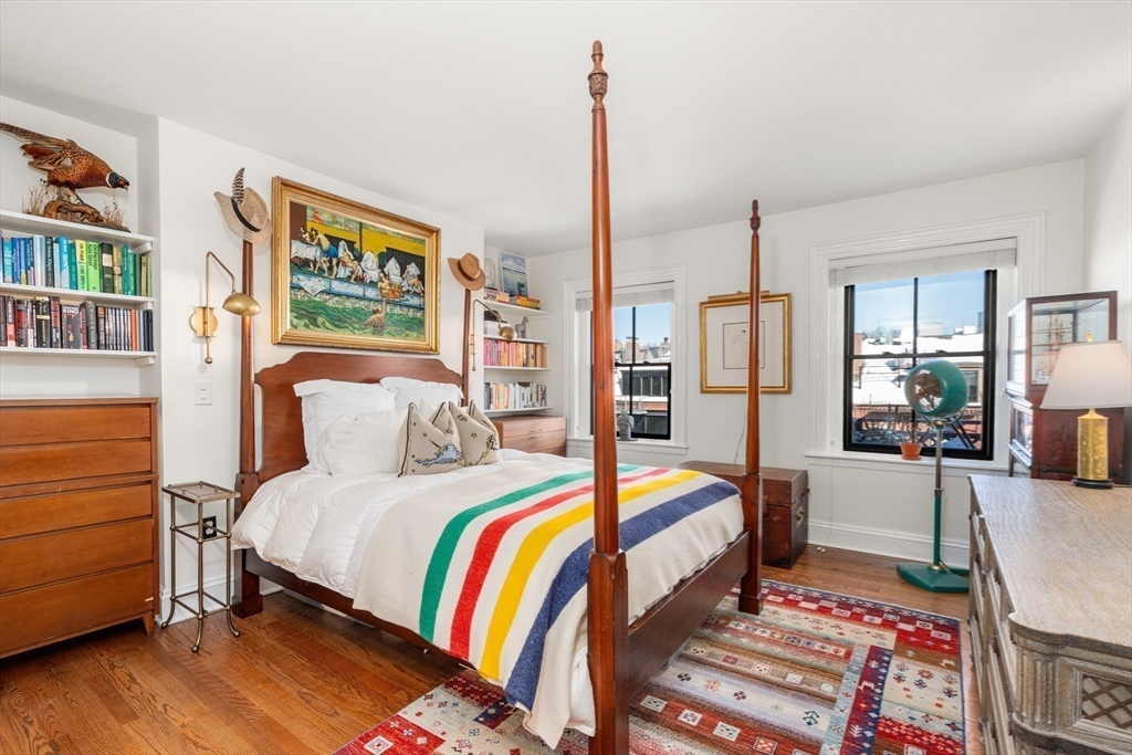 13 Upton Street, Unit 6 Boston, MA 02118 - Photo 12 of 27 a bedroom with a bed and a table
