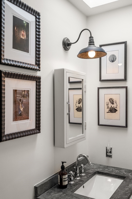 13 Upton Street, Unit 6 Boston, MA 02118 - Photo 19 of 27 a bathroom with a sink and a mirror