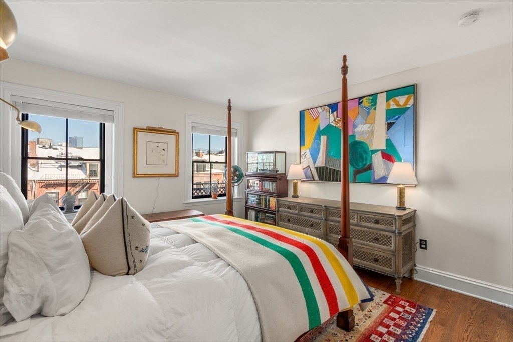 13 Upton Street, Unit 6 Boston, MA 02118 - Photo 8 of 27 a bed room with a bed and a painting on the wall