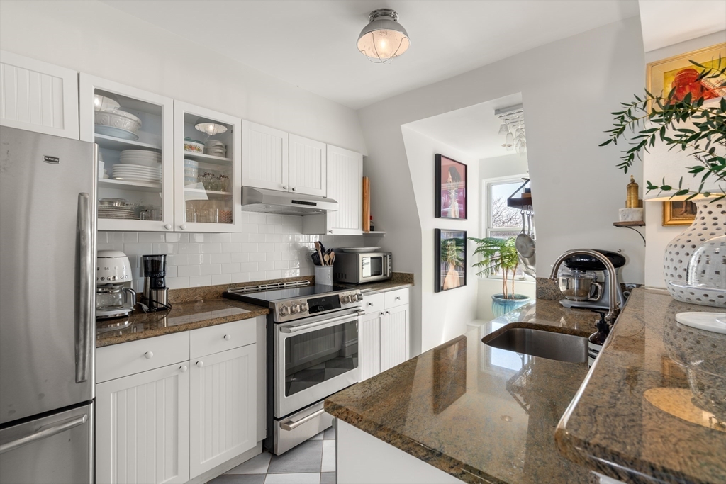 13 Upton Street, Unit 6 Boston, MA 02118 - Photo 10 of 27 a kitchen with granite countertop a sink stainless steel appliances and cabinets