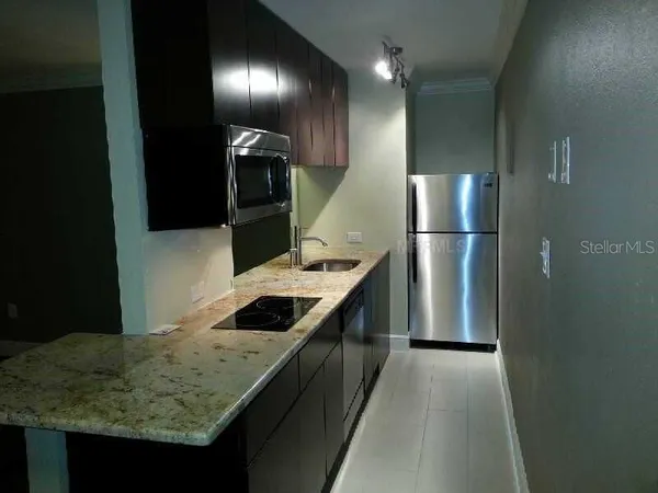 a kitchen with a sink and refrigerator