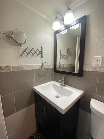 a white toilet sitting next to a bathtub