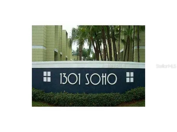 a view of a living room with a sink and mirror