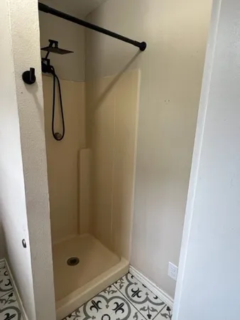 a bathroom with a glass shower door