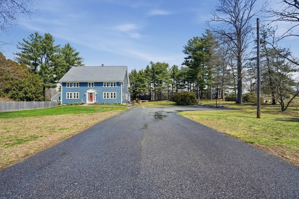 61 Main Street Hanover, MA 02339 - Photo 3 of 38 a view of a house with a big yard and palm trees