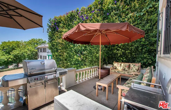 an outdoor space with furniture and umbrella
