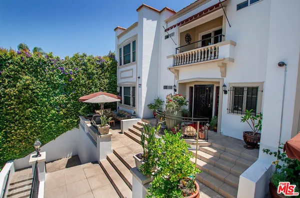 a view of house with outdoor space and sitting area