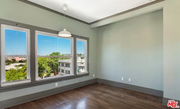 a view of a livingroom with wooden floor and a window