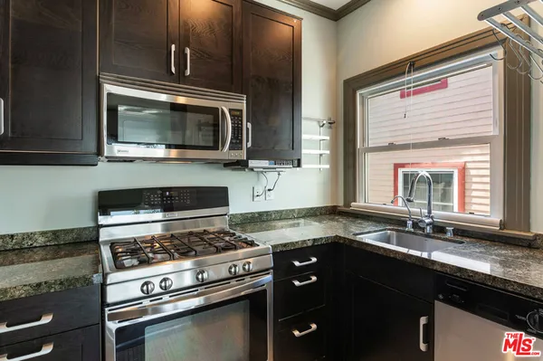 a kitchen with a stove microwave and sink