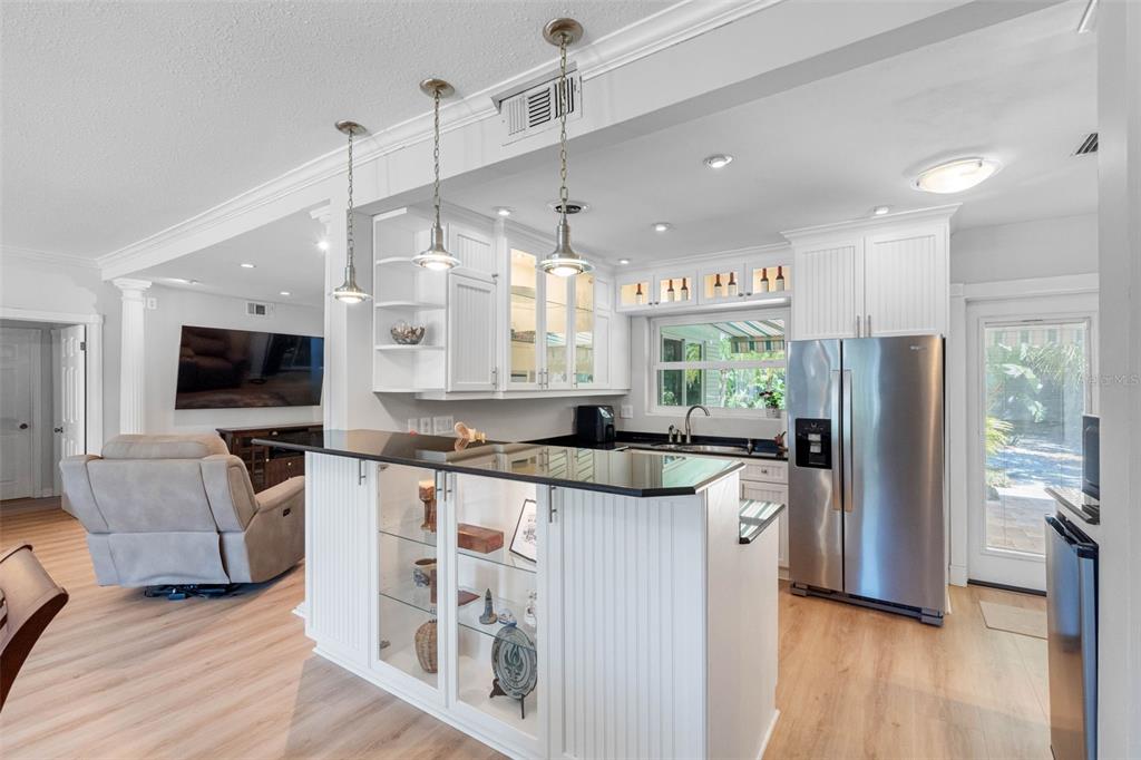 101 Osceola Road Belleair, FL 33756 - Photo 11 of 33 a kitchen with stainless steel appliances granite countertop a refrigerator a stove a sink and a oven with wooden floor