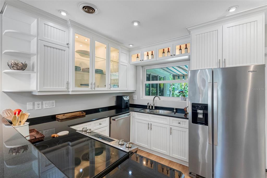 101 Osceola Road Belleair, FL 33756 - Photo 13 of 33 a kitchen with stainless steel appliances granite countertop a sink stove and refrigerator