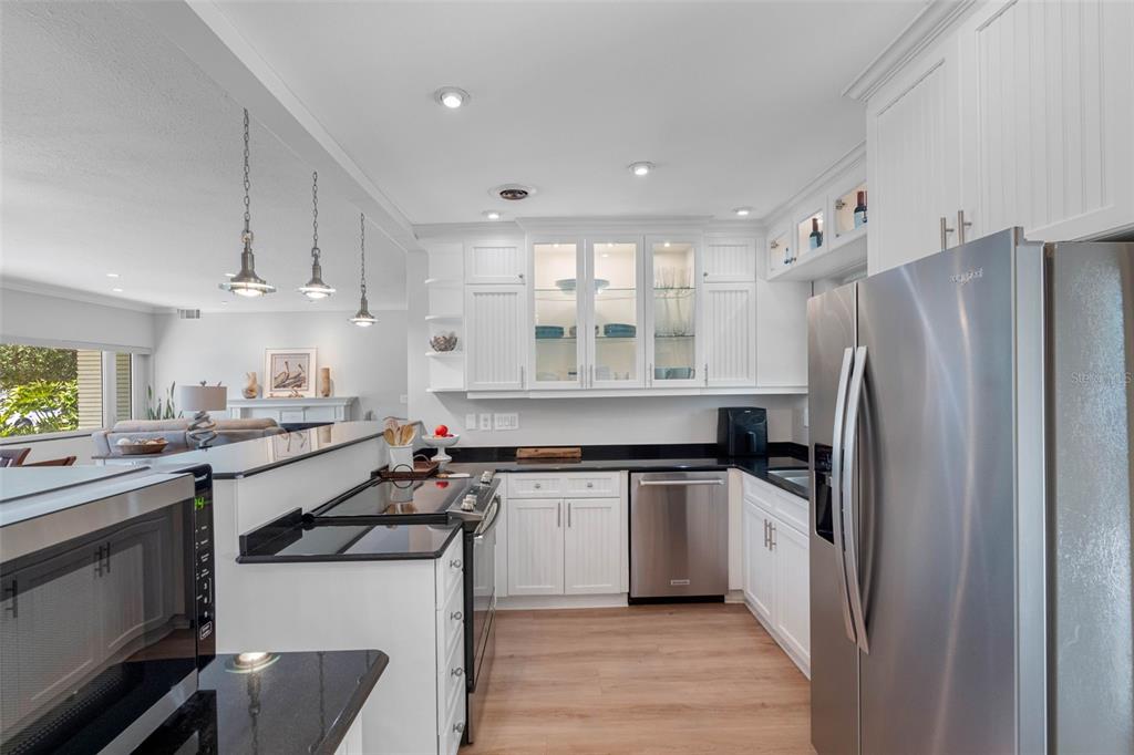 101 Osceola Road Belleair, FL 33756 - Photo 14 of 33 a kitchen with stainless steel appliances a sink stove and refrigerator