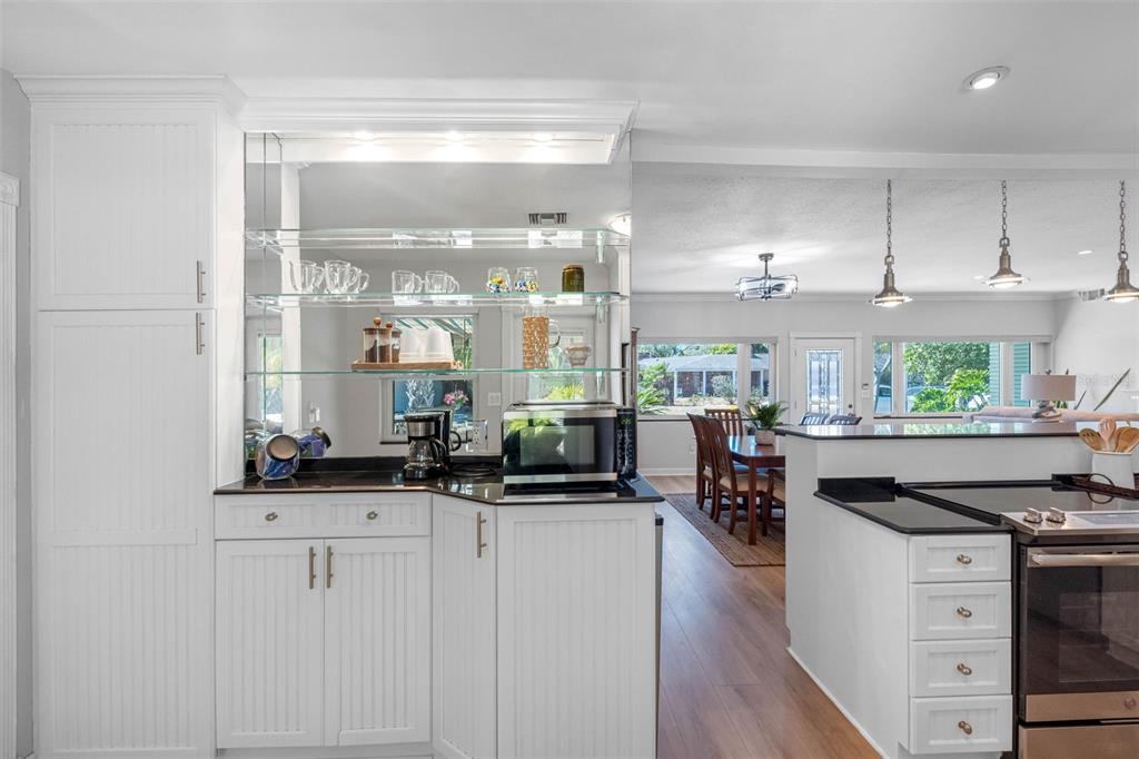 101 Osceola Road Belleair, FL 33756 - Photo 15 of 33 a kitchen with stainless steel appliances kitchen island granite countertop a stove and a view of living room
