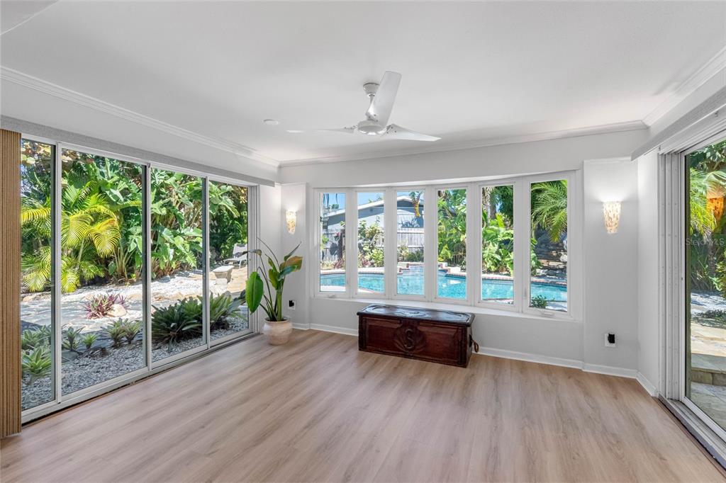 101 Osceola Road Belleair, FL 33756 - Photo 20 of 33 an empty room with wooden floor and windows