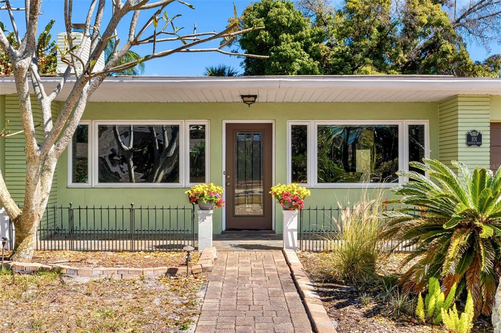 101 Osceola Road Belleair, FL 33756 - Photo 2 of 33 front view of a house with a garden