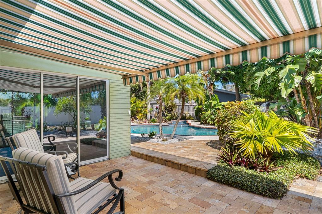 101 Osceola Road Belleair, FL 33756 - Photo 21 of 33 a view of a patio with table and chairs and potted plants