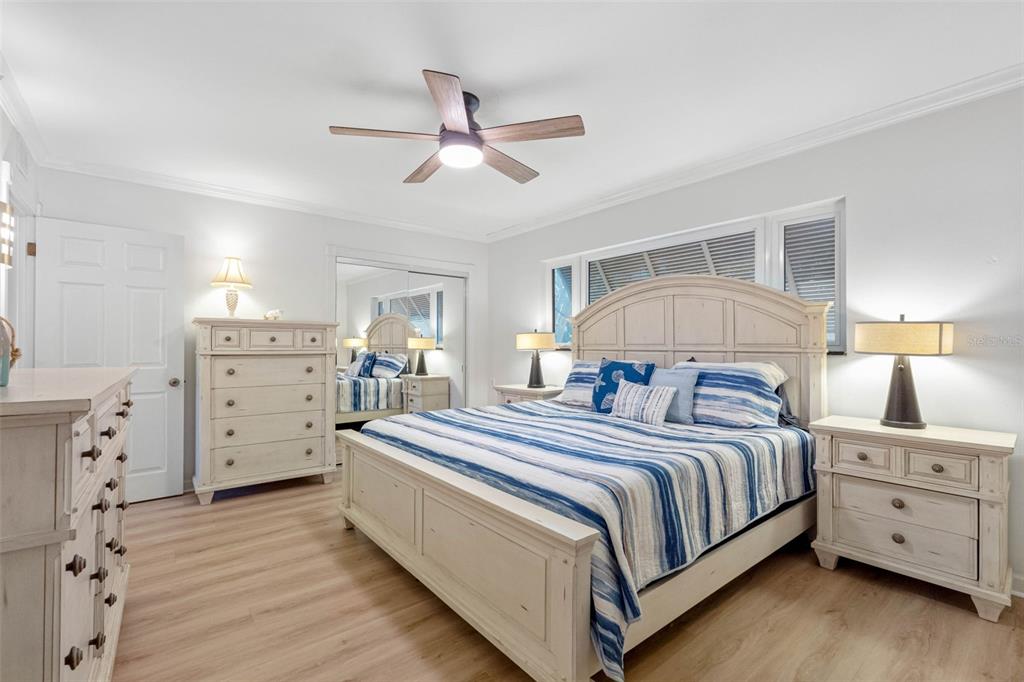 101 Osceola Road Belleair, FL 33756 - Photo 28 of 33 a bedroom with a large bed and a chandelier