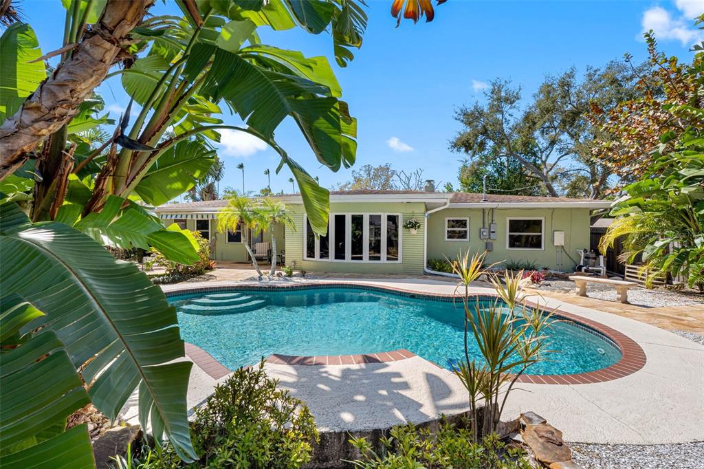 101 Osceola Road Belleair, FL 33756 - Photo 3 of 33 a view of a house with backyard sitting area and swimming pool