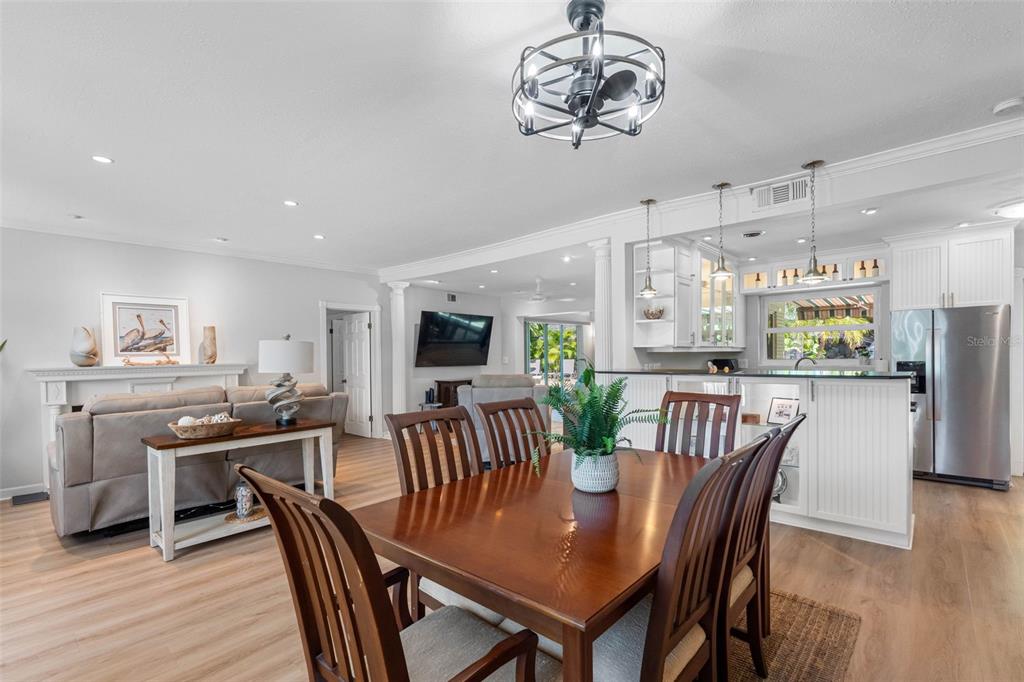 101 Osceola Road Belleair, FL 33756 - Photo 6 of 33 a view of a dining room with furniture wooden floor and chandelier