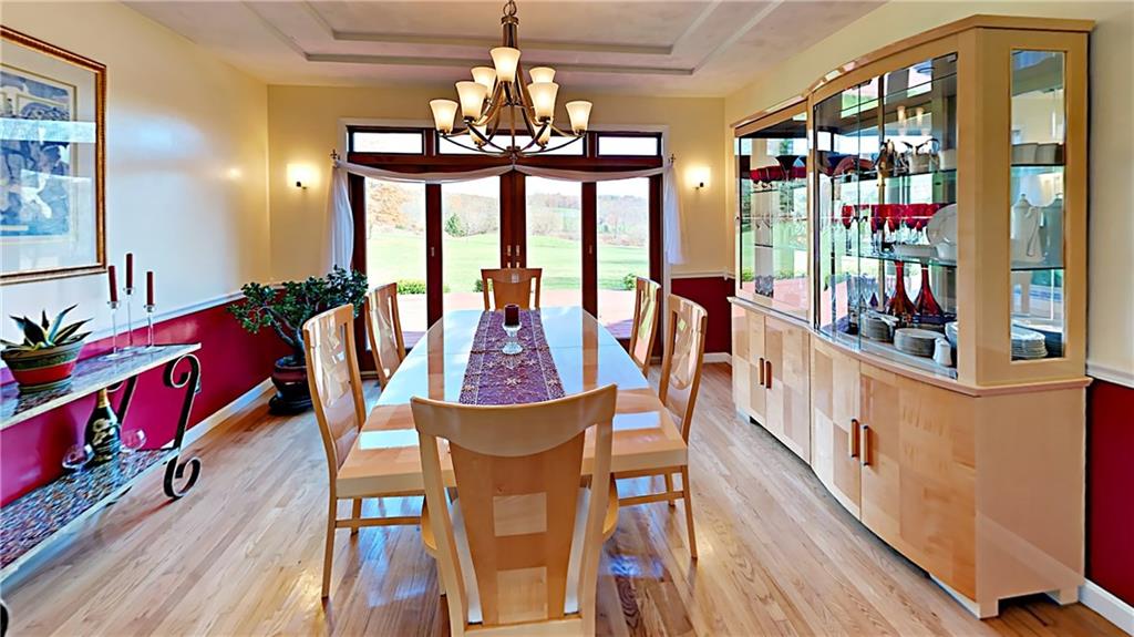 5766 Evans Road Export, PA 15632 - Photo 7 of 25 Formal dining room with hardwood flooring, ceiling details, and access to deck.