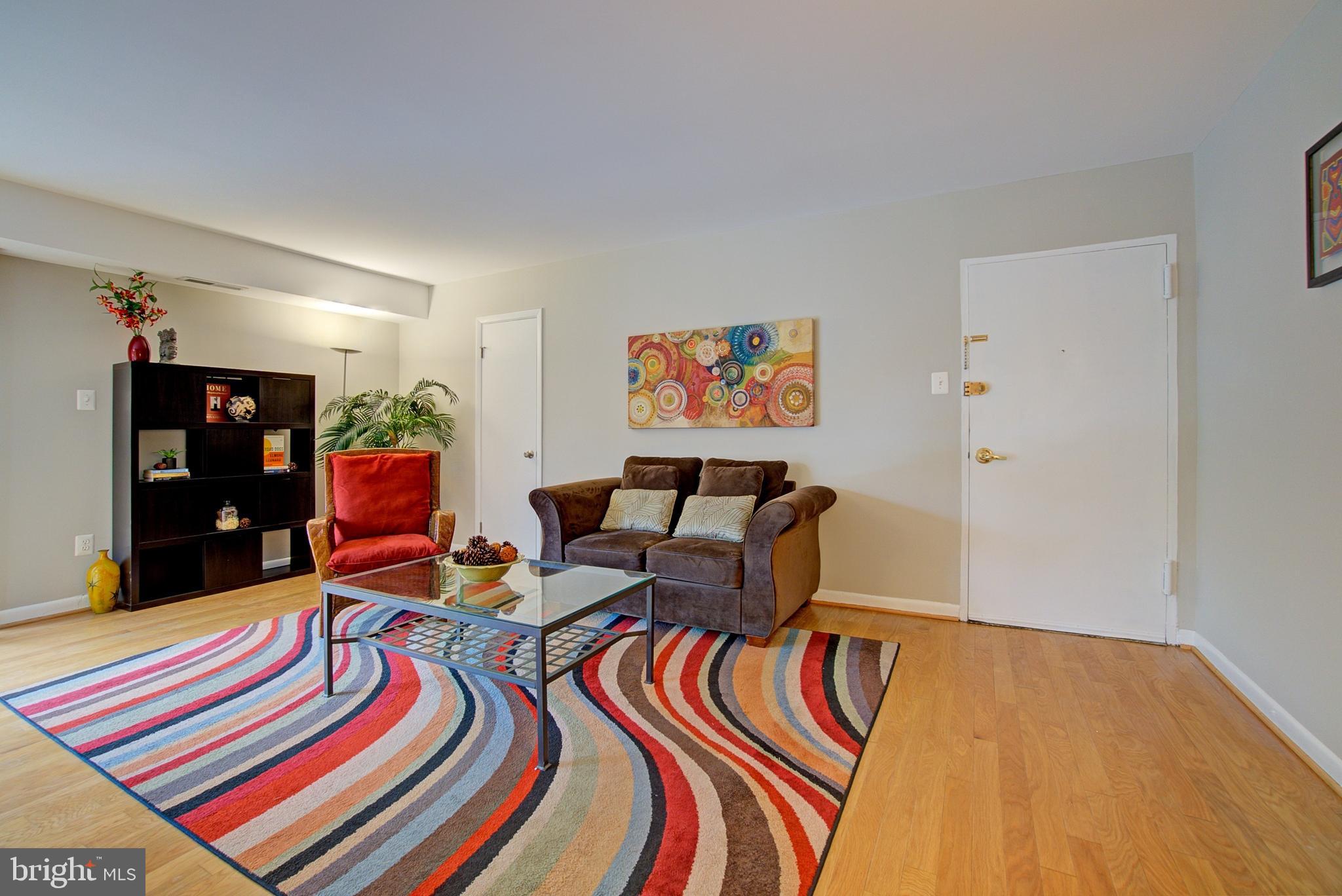 8706 Manchester Road, Unit 5 Silver Spring, MD 20901 - Photo 2 of 25 a living room filled with furniture and rug